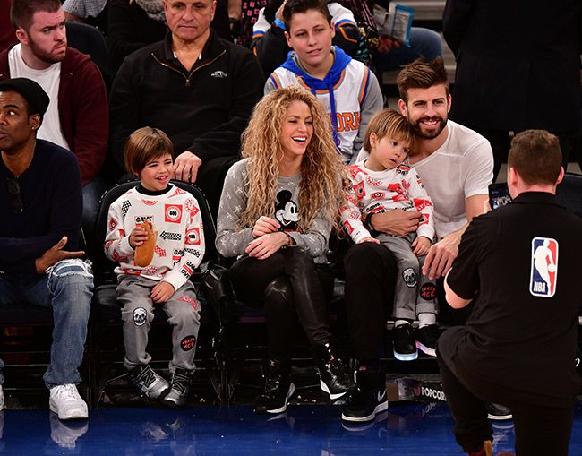 Shakira and Gerard Pique watching a basketball game with their sons