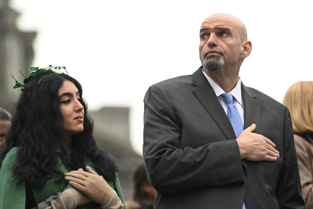 U.S. Senator John Fetterman (D-PA) and his wife, Gisele Barreto Fetterman, stand during the singing of the National Anthem before Josh Shapiro is sworn in as Governor of Pennsylvania