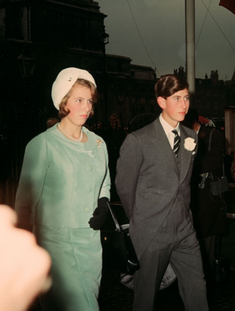 Teenager Princess Anne in a blue skirt suit with her older brother Prince Charles