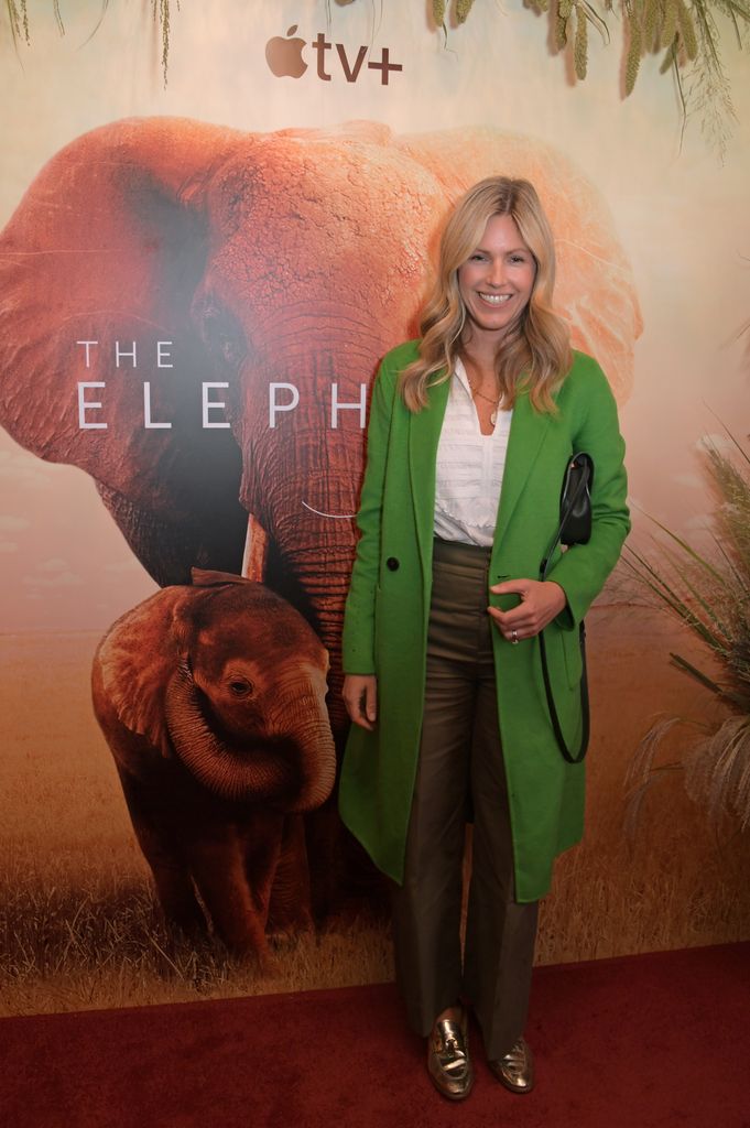 Marina Fogle in a green coat smiling in front of a step and repeat at a TV show premiere in 2019
