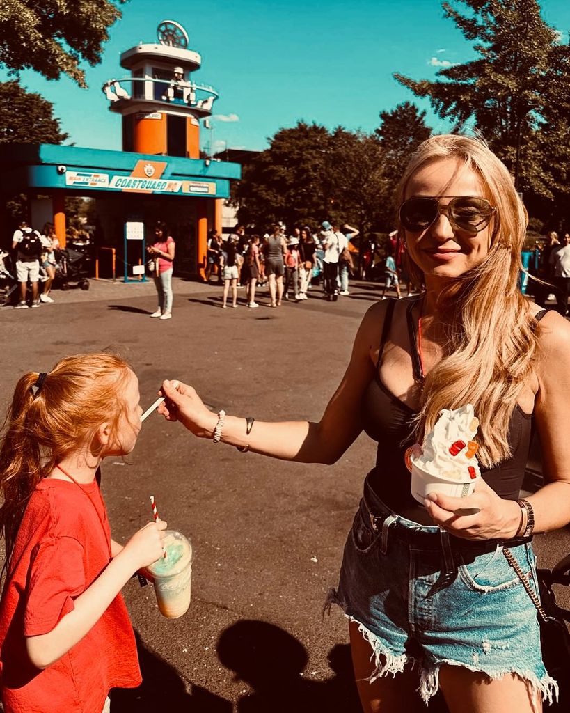 mother feeding daughter ice cream