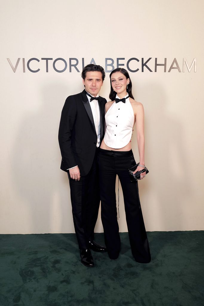 couple at fashion show in tuxedos 