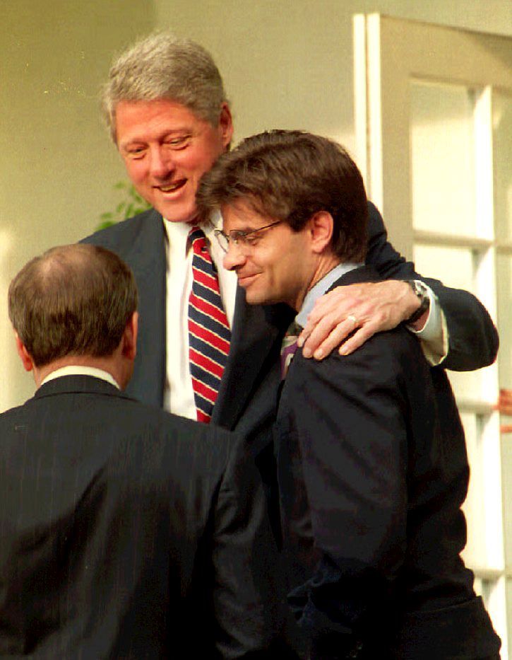 President Bill Clinton speaks to White House Chief of Staff Thomas McLarty 29 May, 1993 with his arm around George Stephanopoulos in the Rose Garden of the White House.