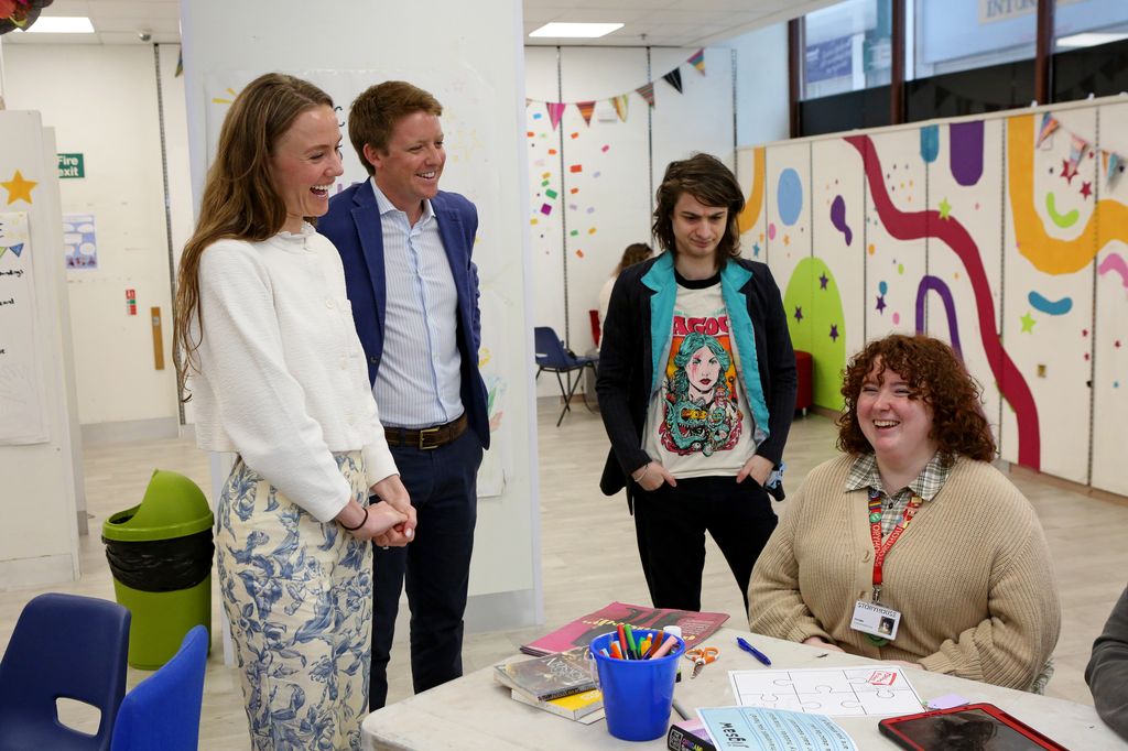 Olivia Henson and the Duke of Westminster laughing with a group of young people