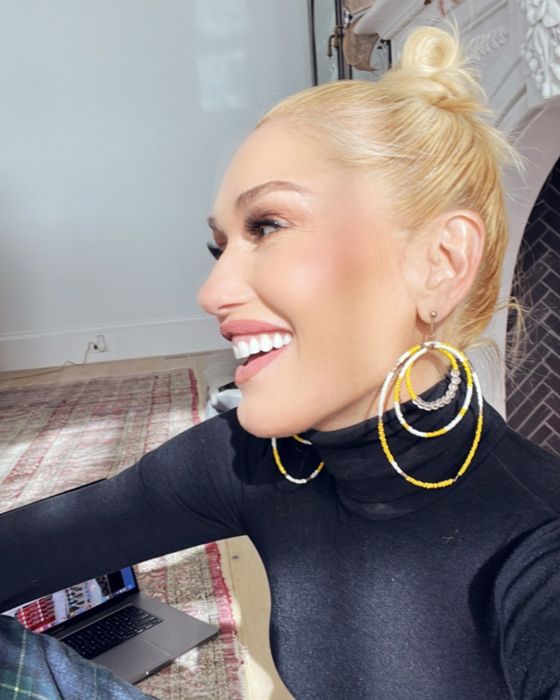 Gwen Stefani smiling in a black polo neck top