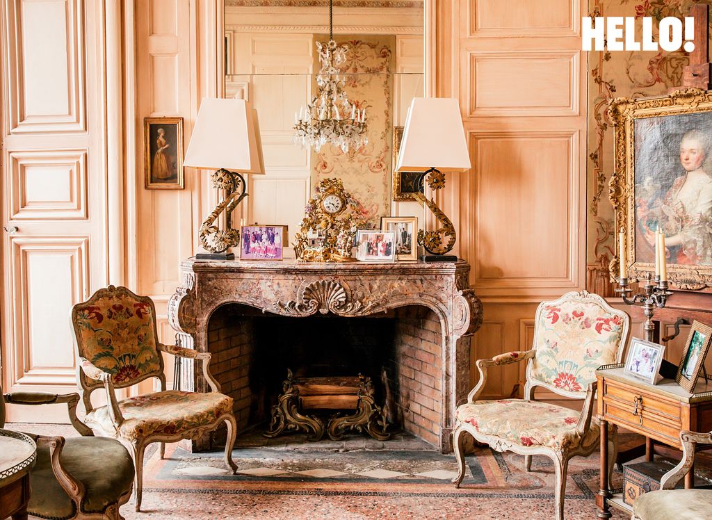 A sitting area with a fireplace inside Château de Pennautier