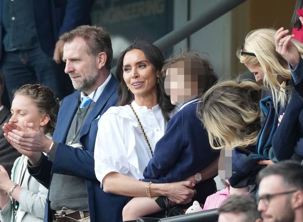 Christine held her son and was all smiles from the sidelines