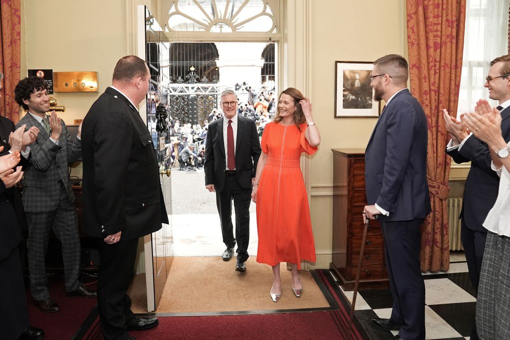 Prime Minister and leader of the Labour Party, Keir Starmer, and his wife Victoria, are greeted as they arrive inside 10 Downing Street