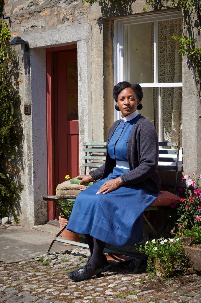 nurse sitting on bench outside house