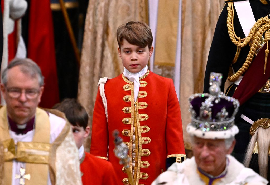 Page of Honour Prince George of Wales and Britain's King Charles III wearing the Imperial state Crown leave Westminster Abbey after the Coronation Ceremonies in central London on May 6, 2023. 