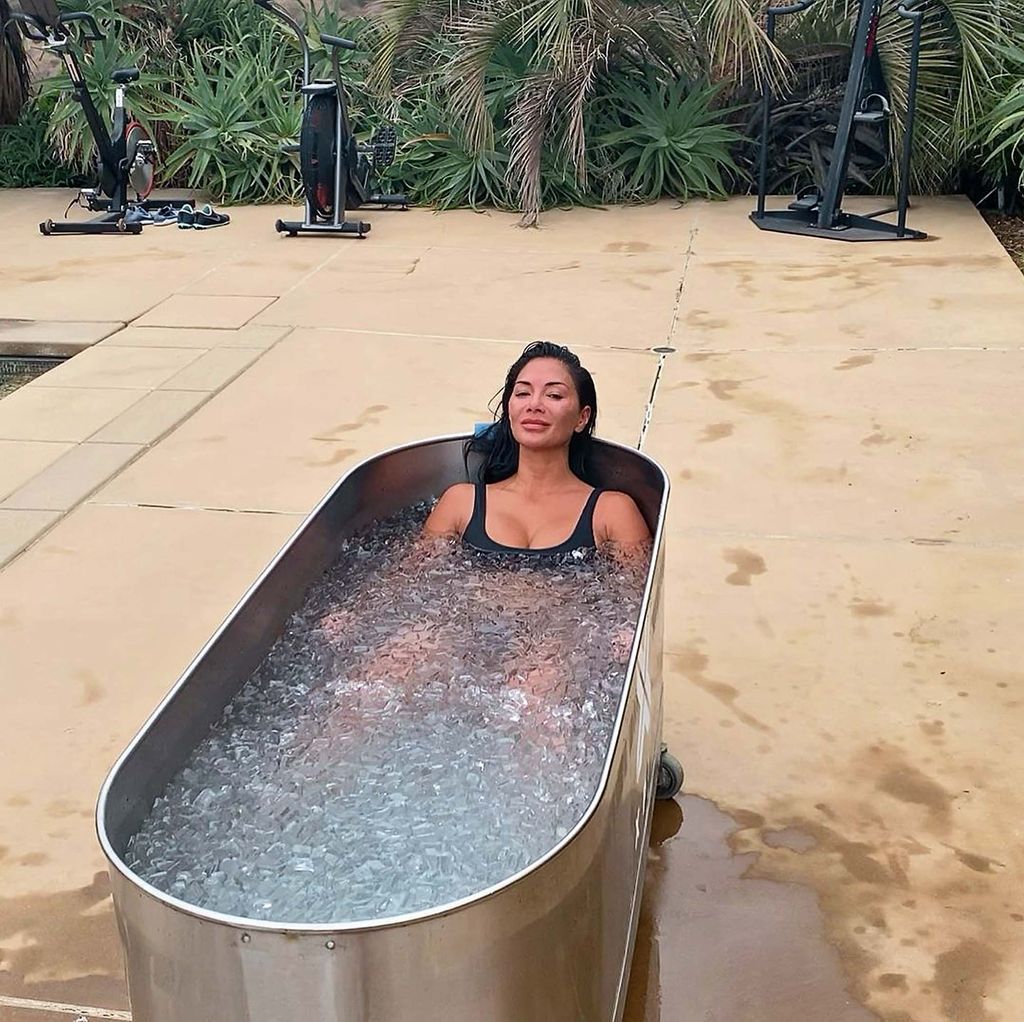 Nicole Scherzinger in black swimsuit relaxing in ice bath