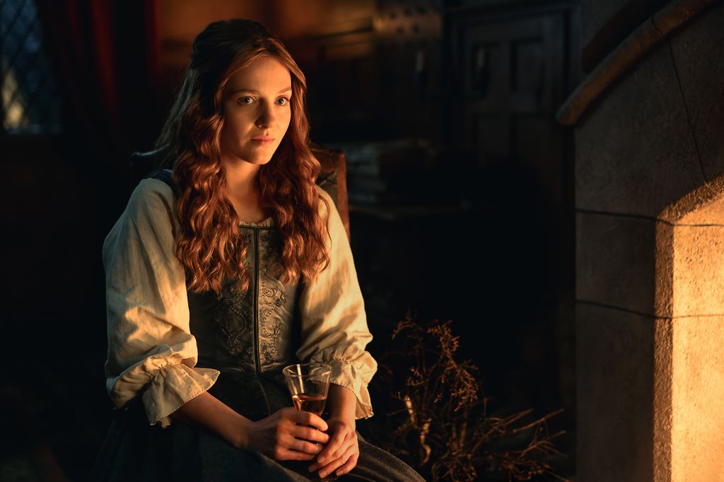 woman with long ginger hair in dimly lit room