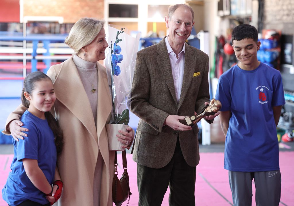 Prince Edward holding a trophy next to sophie and kids
