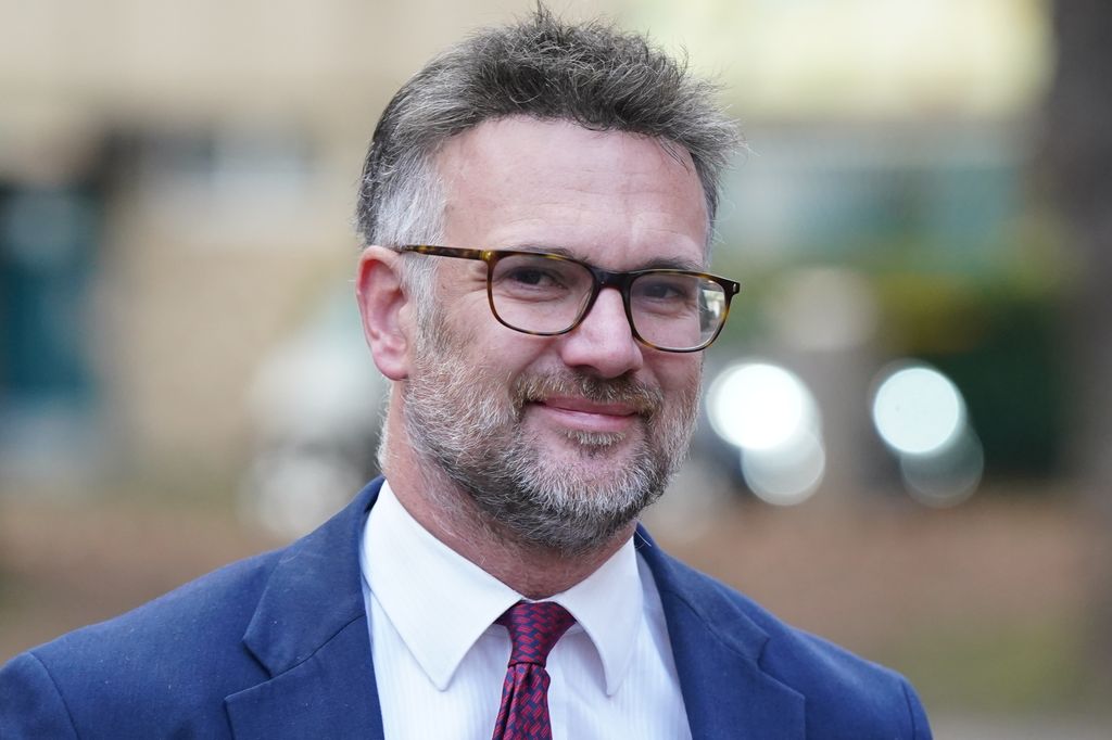 close-up of man with beard in suit smiling
