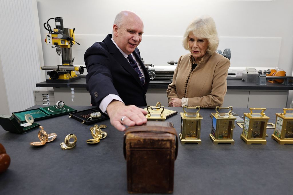 Queen Camilla being shown carriage clocks