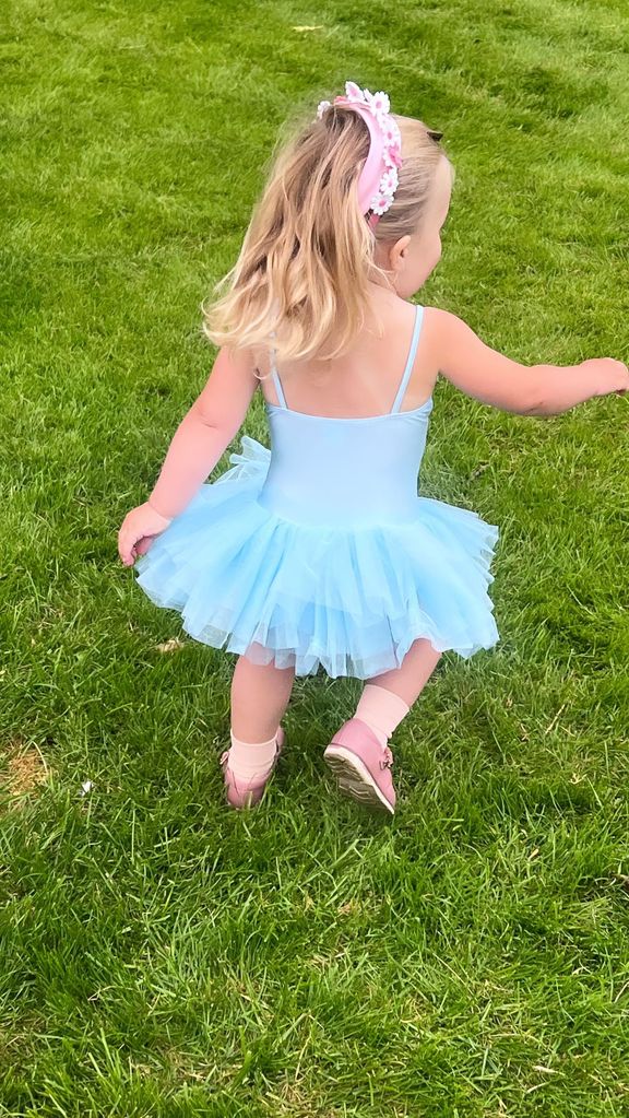 A photo of Romy Johnson wearing a blue tutu