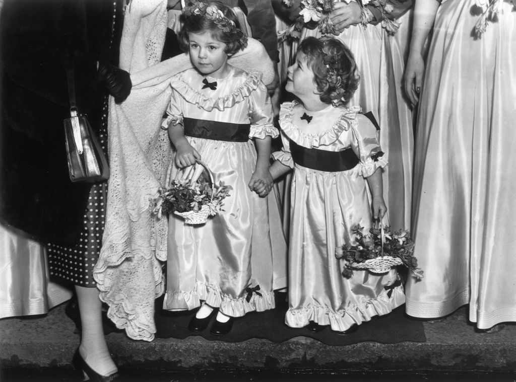A black-and-white image of a young Queen Camilla and Annabel Elliot as bridemaids