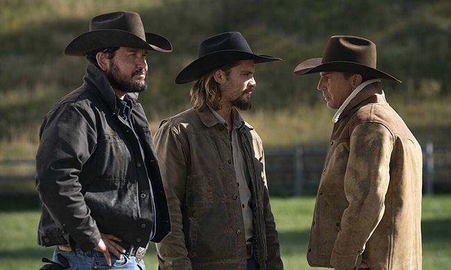 Cast of Yellowstone stand in field during episode