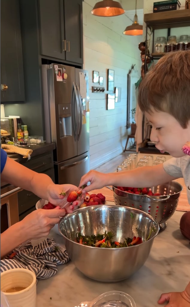 Screenshot of a video posted by Joanna Gaines on Instagram June 2023 sharing a glimpse of hulling some strawberries to make jam with her son Crew