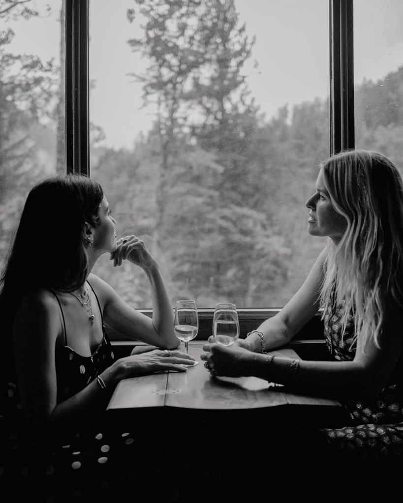 Sarah Wright Olsen and Nikki Reed sit in a train car