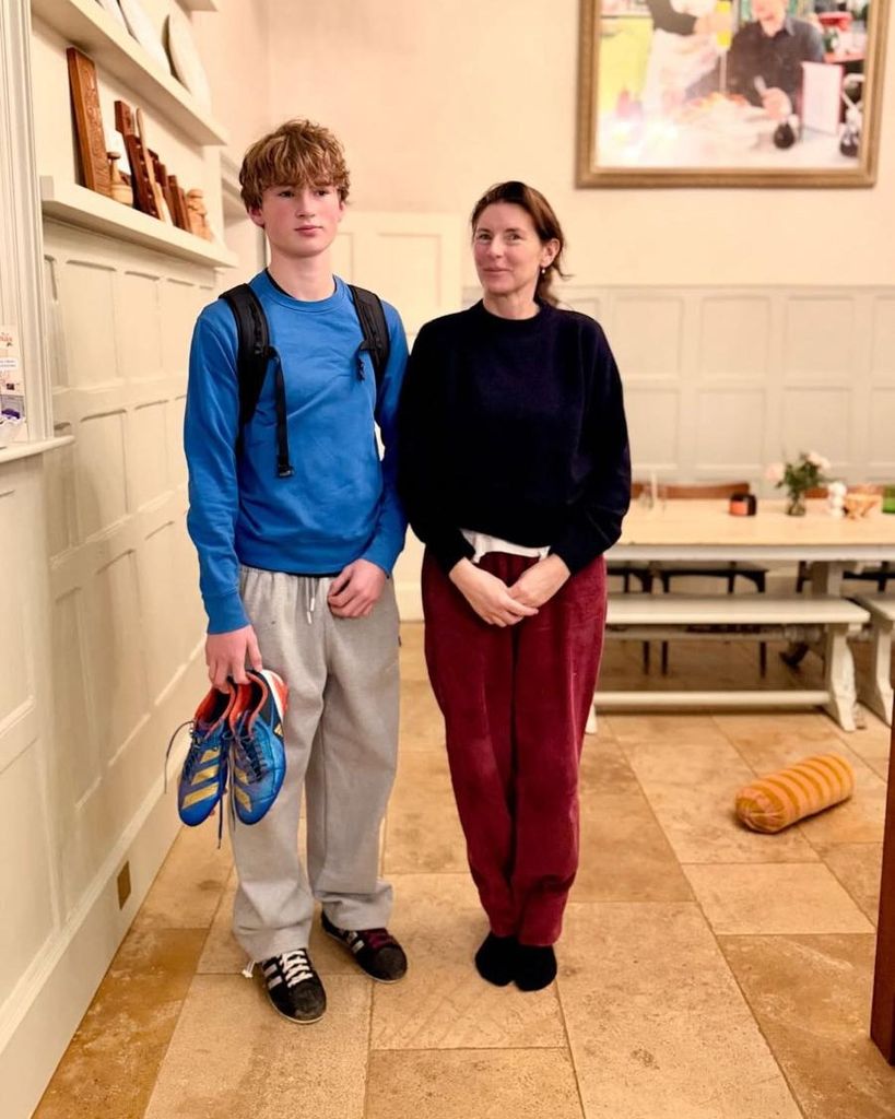 river oliver standing in home dining room beside jools oliver in tracksuit