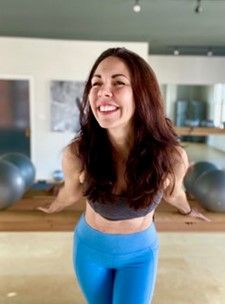 Nesse Cannon in blue leggings smiling 