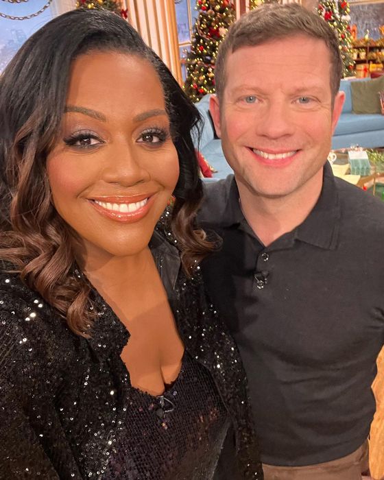 Alison Hammond and Dermot OLeary posing for a selfie, smiling in christmas clothes