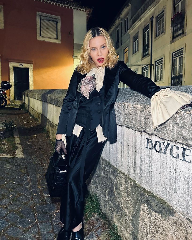 Madonna wearing a tailored jacket, waistcoat, blouse and trousers