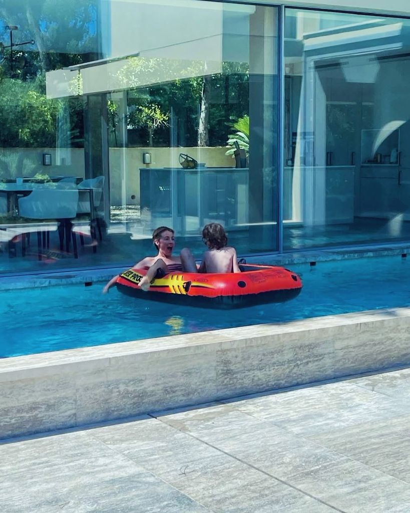 Cat Deeley and her son floating in a dingy while in pool on holiday