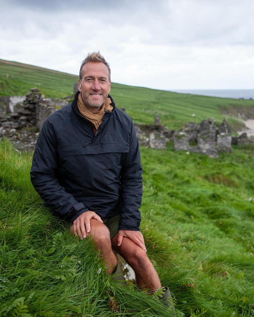 Ben Fogle wearing Buffalo jacket posing on a grassy hill
