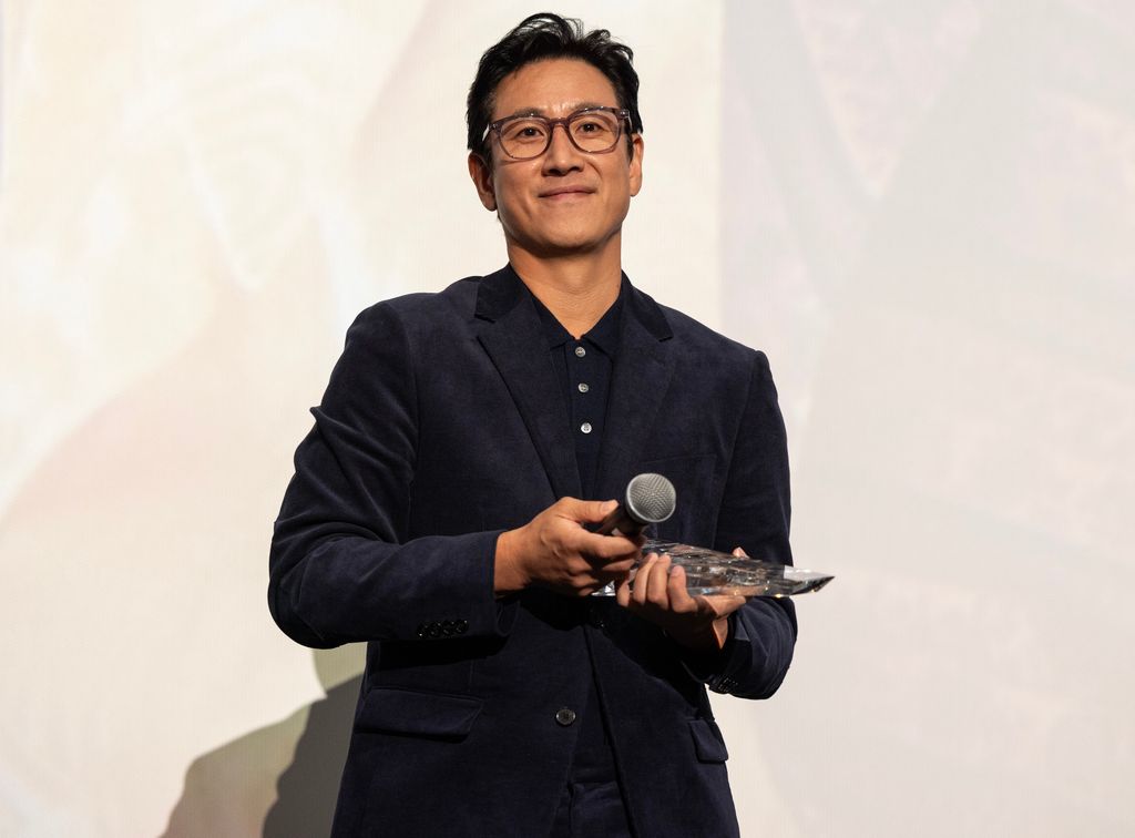 CHICAGO, ILLINOIS - OCTOBER 07: Actor Lee Sun Kyun receives the award for "Excellent Achievement in Film" during the introduction of the "Killing Romance" Midwest Premiere at AMC New City 14 on October 07, 2023 in Chicago, Illinois. (Photo by Barry Brecheisen/Getty Images)