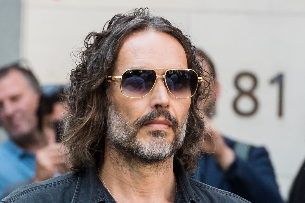 British comedian Russell Brand leaves Westminster Magistrates Court following a first hearing after being accused of two charges of rape