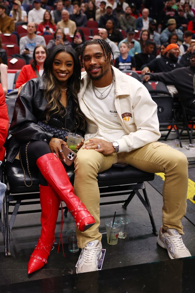 Simone Biles and Jonathan Owens pose for a photo during the first half between the Chicago Bulls and the Minnesota Timberwolves at the United Center on November 07, 2024 in Chicago, Illinois. 