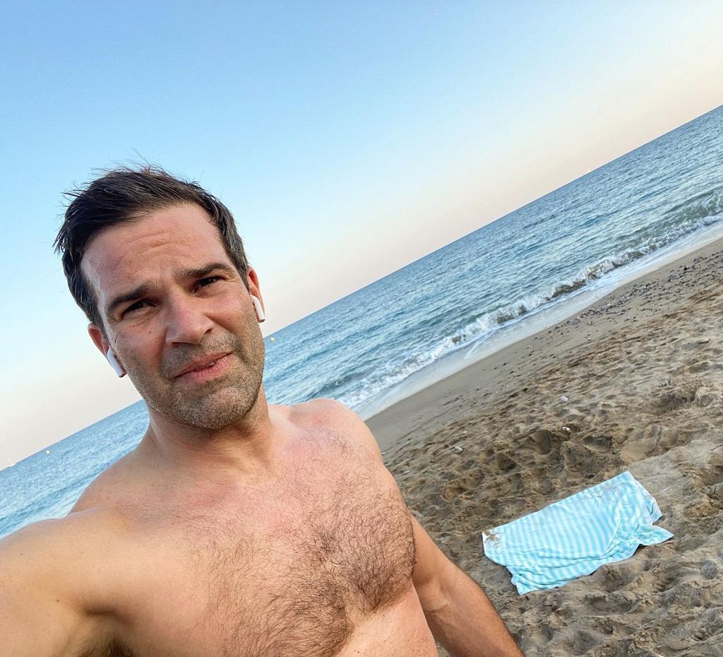 man posing for selfie by sea 