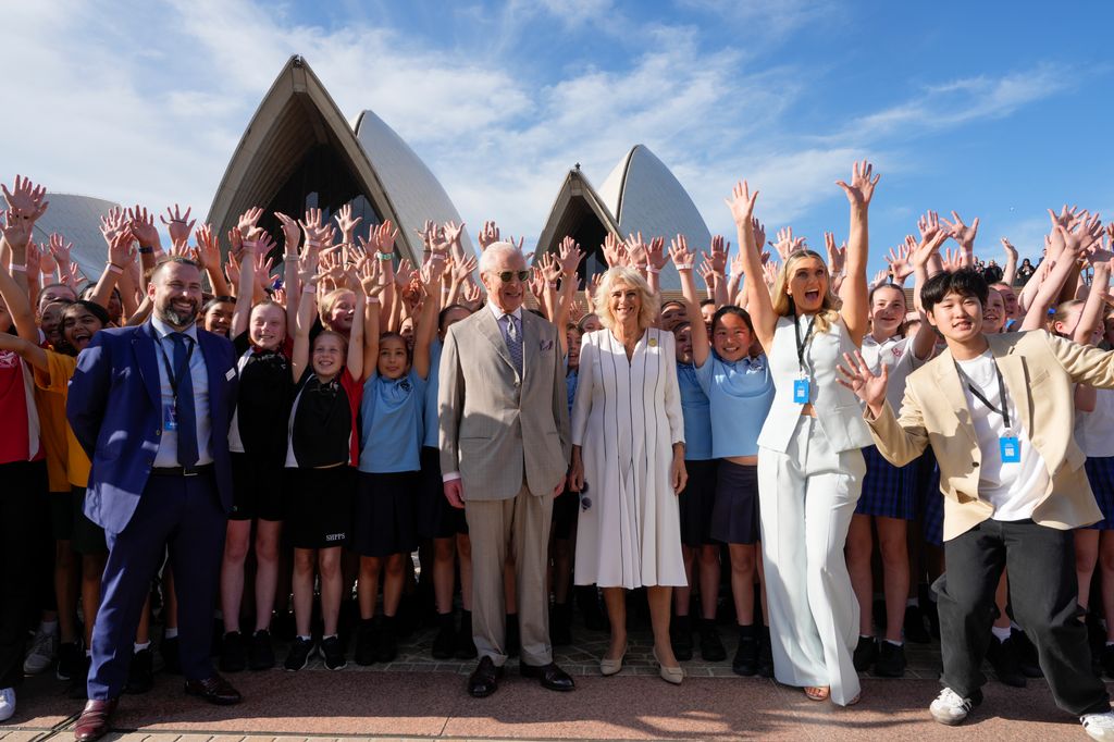 Charles and Camilla pose for a group photo in front of the Sydney Opera House