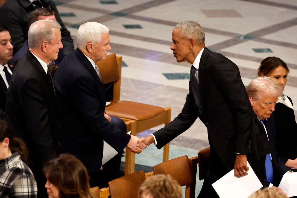 Former U.S. President Barack Obama (R) greets former U.S. Vice President Mike Pence during the state funeral for former U.S. President Jimmy Carter at Washington National Cathedral on January 09, 2025 in Washington, DC. President Joe Biden declared today a national day of mourning for Carter, the 39th President of the United States, who died at the age of 100 on December 29, 2024 at his home in Plains, Georgia.