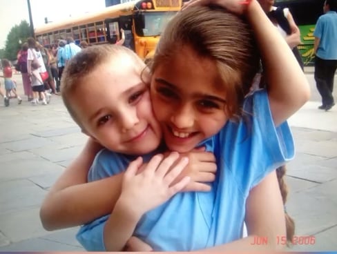 Lourdes and Rocco smile in an adorable childhood candid outside a school bus