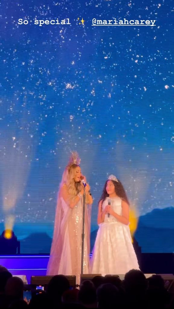 Photo shared by Kim Kardashian to her Instagram Stories November 17, where Mariah Carey is performing on stage with her daughter Monroe, 12, during her Christmas concert in California.