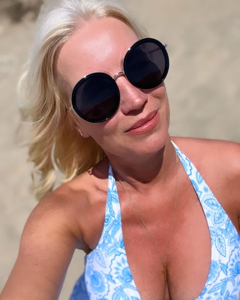 Denise posing for a beach selfie