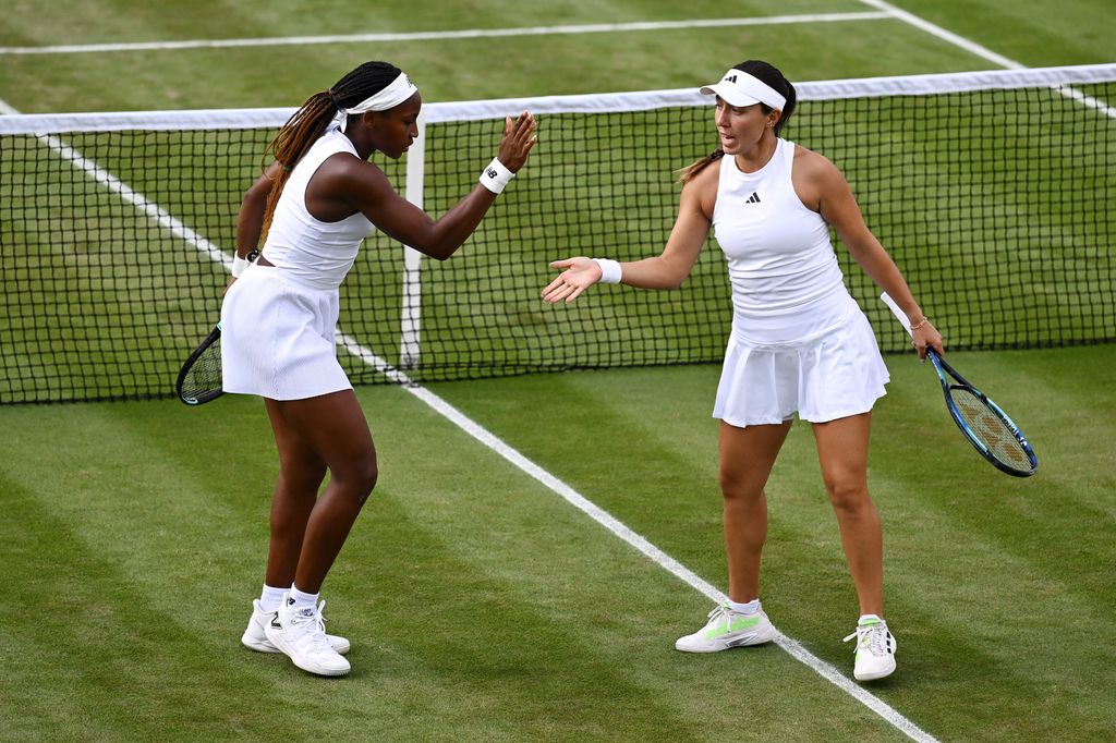 two tennis players celebrating on court 