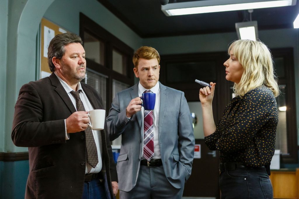 three detectives standing in office