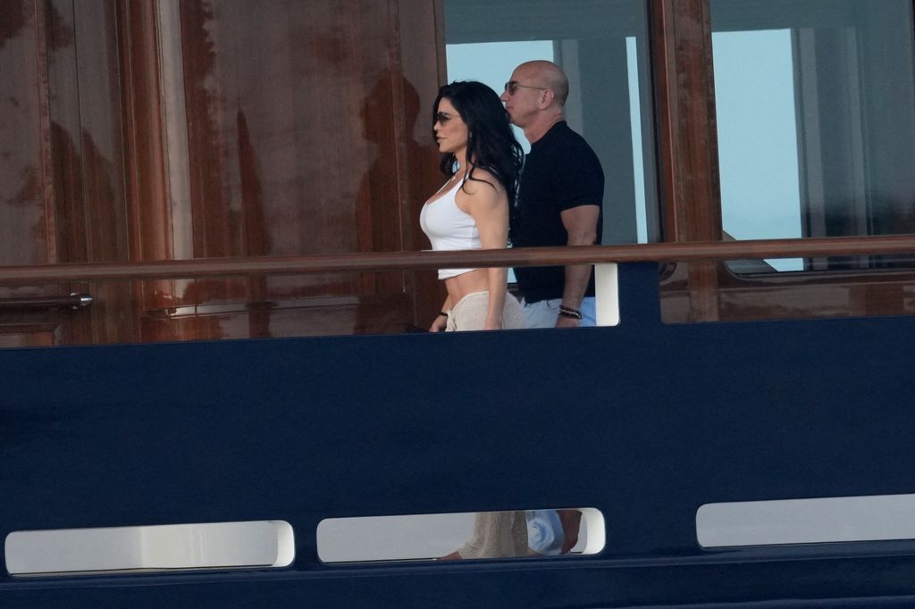 Lauren and Jeff walk alongside each other on his $500million superyacht