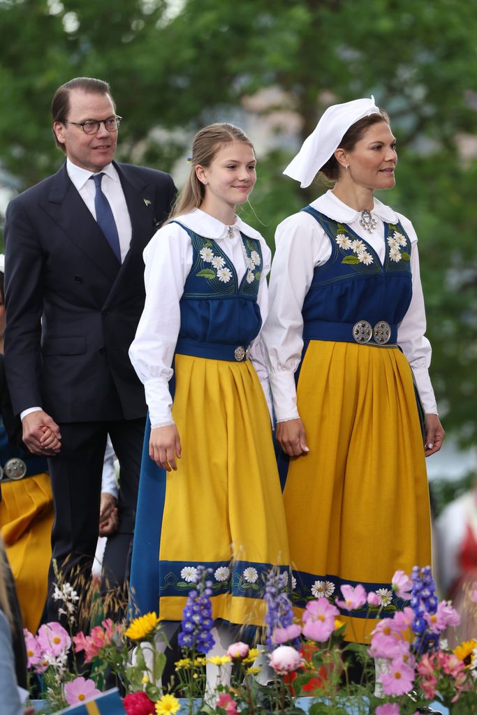 Prince Daniel  in suit Princess Estelle of Sweden and Crown Princess Victoria of Sweden in national dress