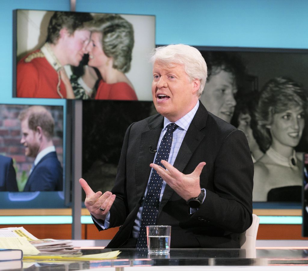 man chatting on live tv in dark suit and tie 