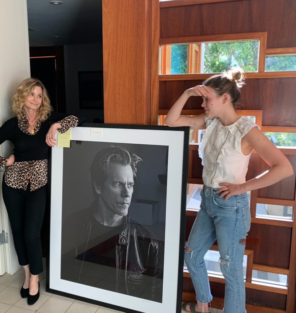 Photo shared by Kyra Sedgwick featuring her daughter Sosie Bacon posing in their Los Angeles home with a massive portrait of Kevin Bacon