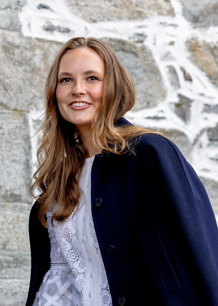 Princess Ingrid Alexandra smiling in navy blazer and lace top