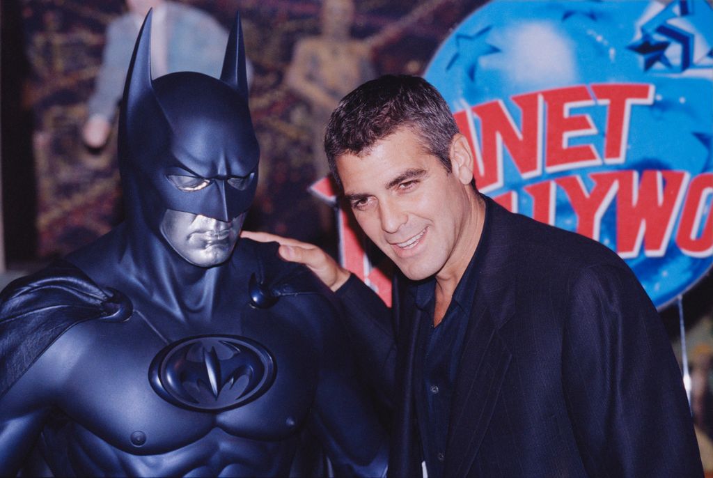 American actor George Clooney poses with a model of Batman during a photocall for his latest film 'Batman and Robin' at Planet Hollywood, London, UK, 23rd June 1997. (Photo by Colin Davey/Getty Images)