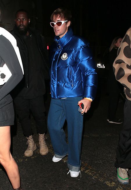 A guest is seen wearing a Louis Vuitton varsity jacket, blue and News  Photo - Getty Images