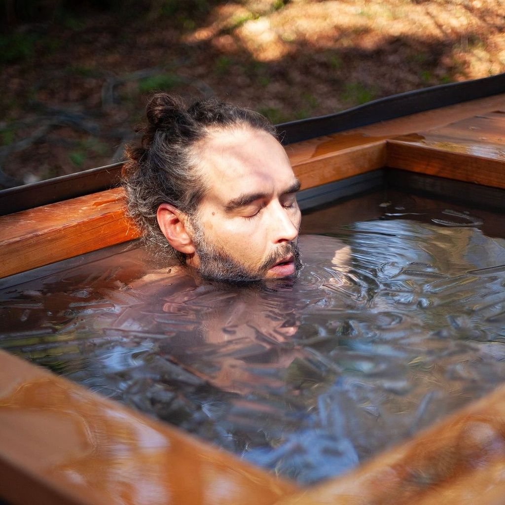 Russell Brand submerged in an ice bath