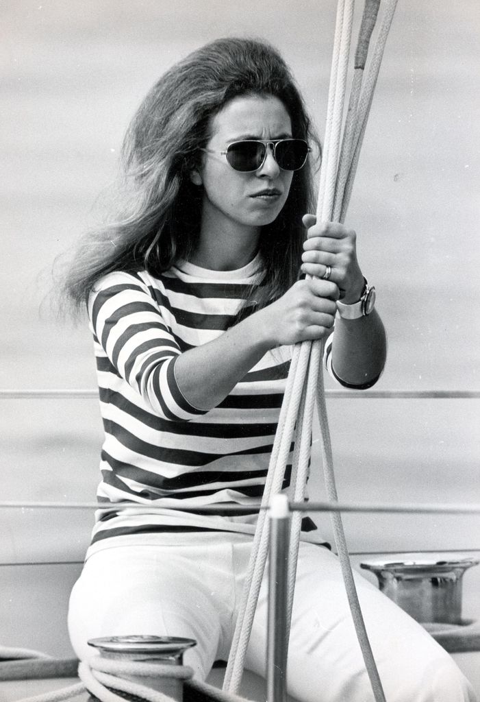 The Princess royal wears a striped tshirt and sunglasses as she wears her hair down while on a yacht